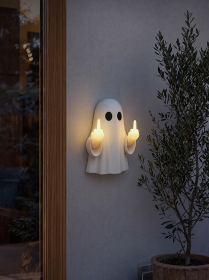 Ghost night light mounted on a wall at dusk, both hands glowing