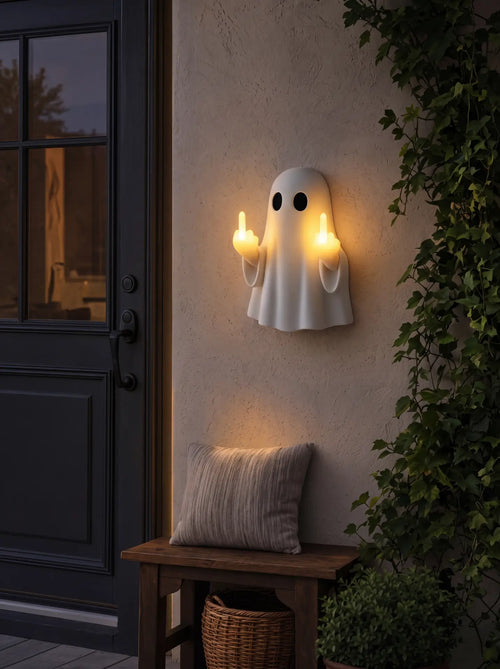 Ghost night light glowing warm on an entryway wall above a wooden bench
